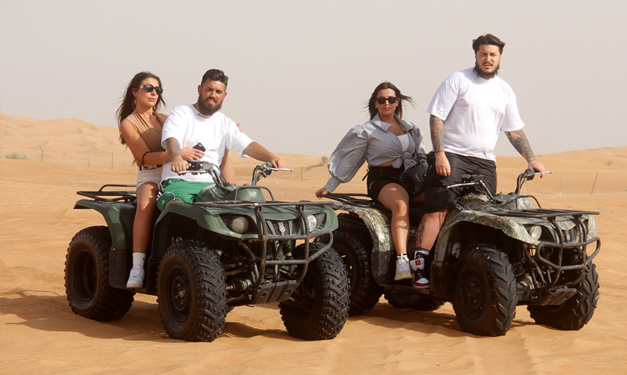 Guest riding 320 CC quad bike over Dubai desert dunes